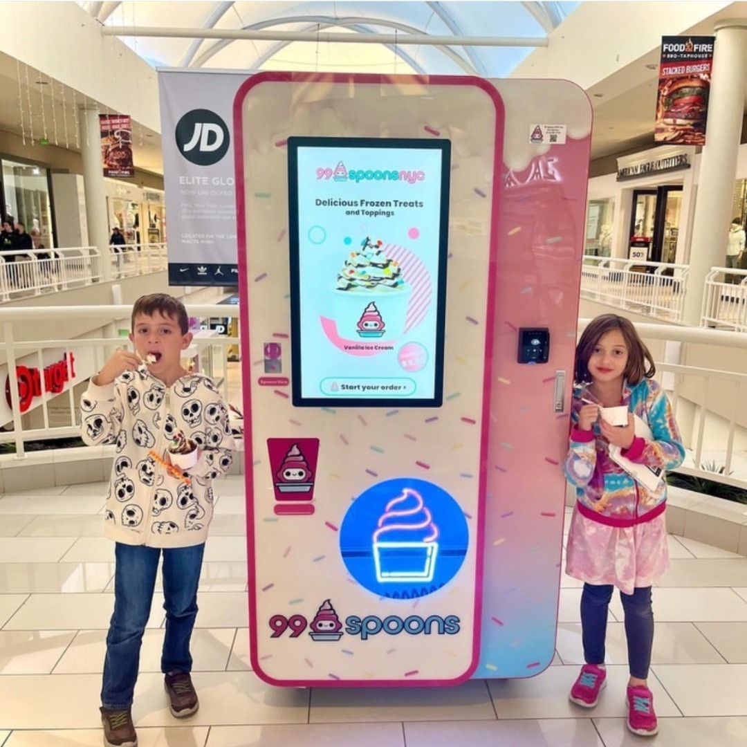 Two kids enjoying 99 Spoons at a mall