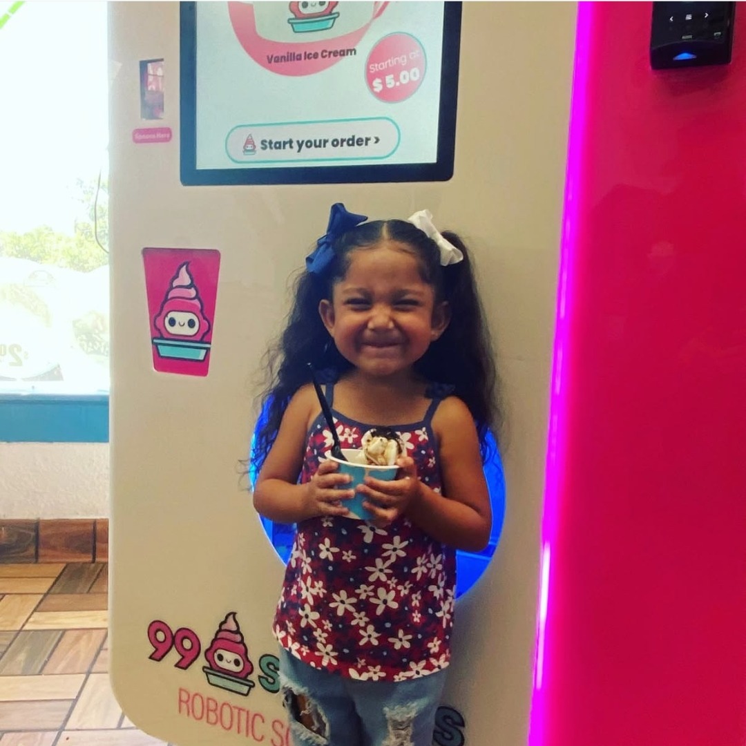 Little girl smiling with 99 Spoons cup
